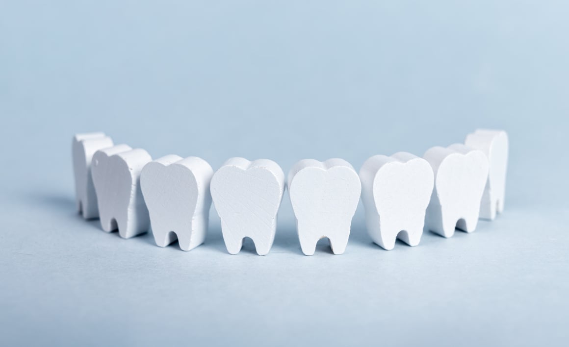 Toy teeth row on blue background